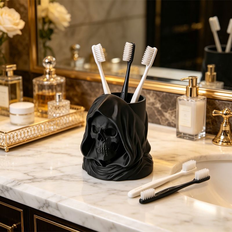 3D-printed hooded skull organizer, perfect for storing toothbrushes and toothpaste in your bathroom. Black.